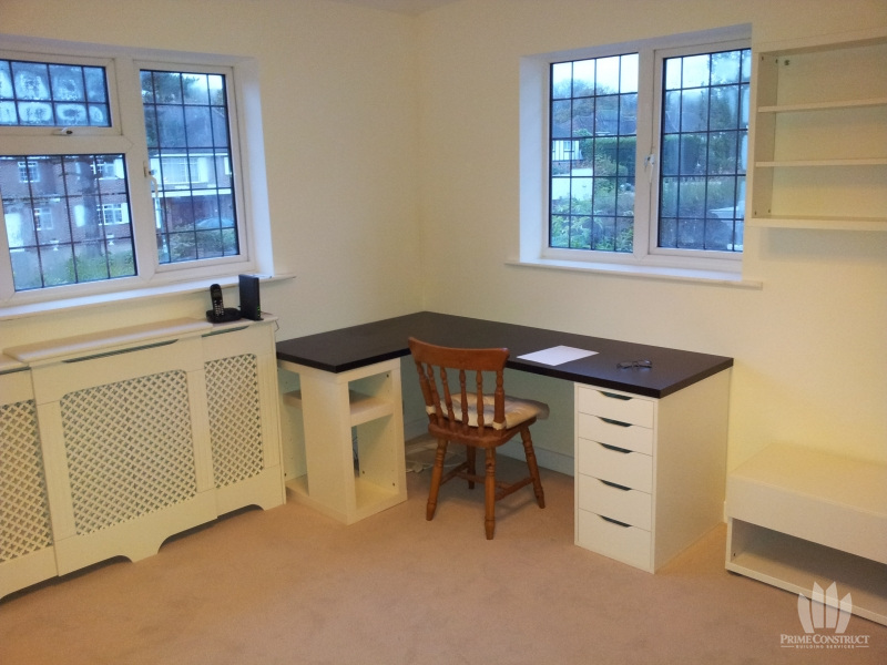 Built-in desk beneath office windows