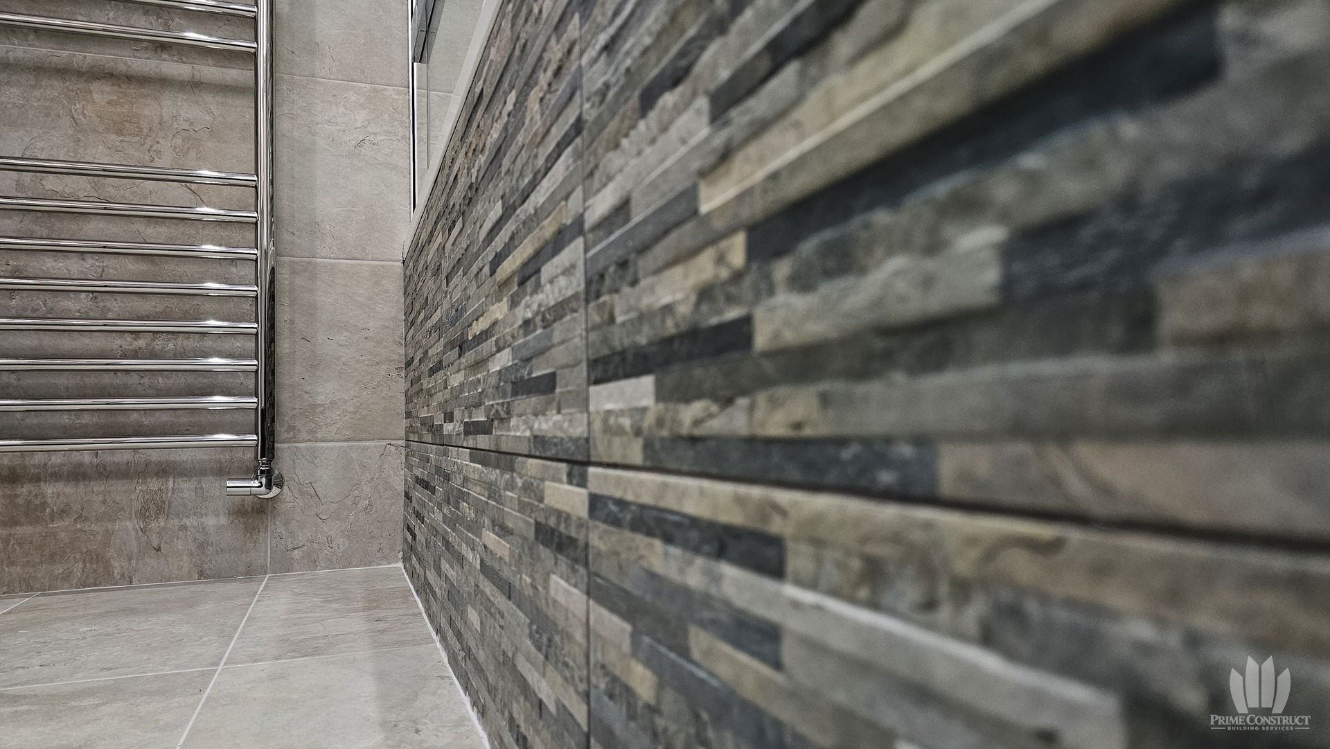 Textured wall tiles and towel rail