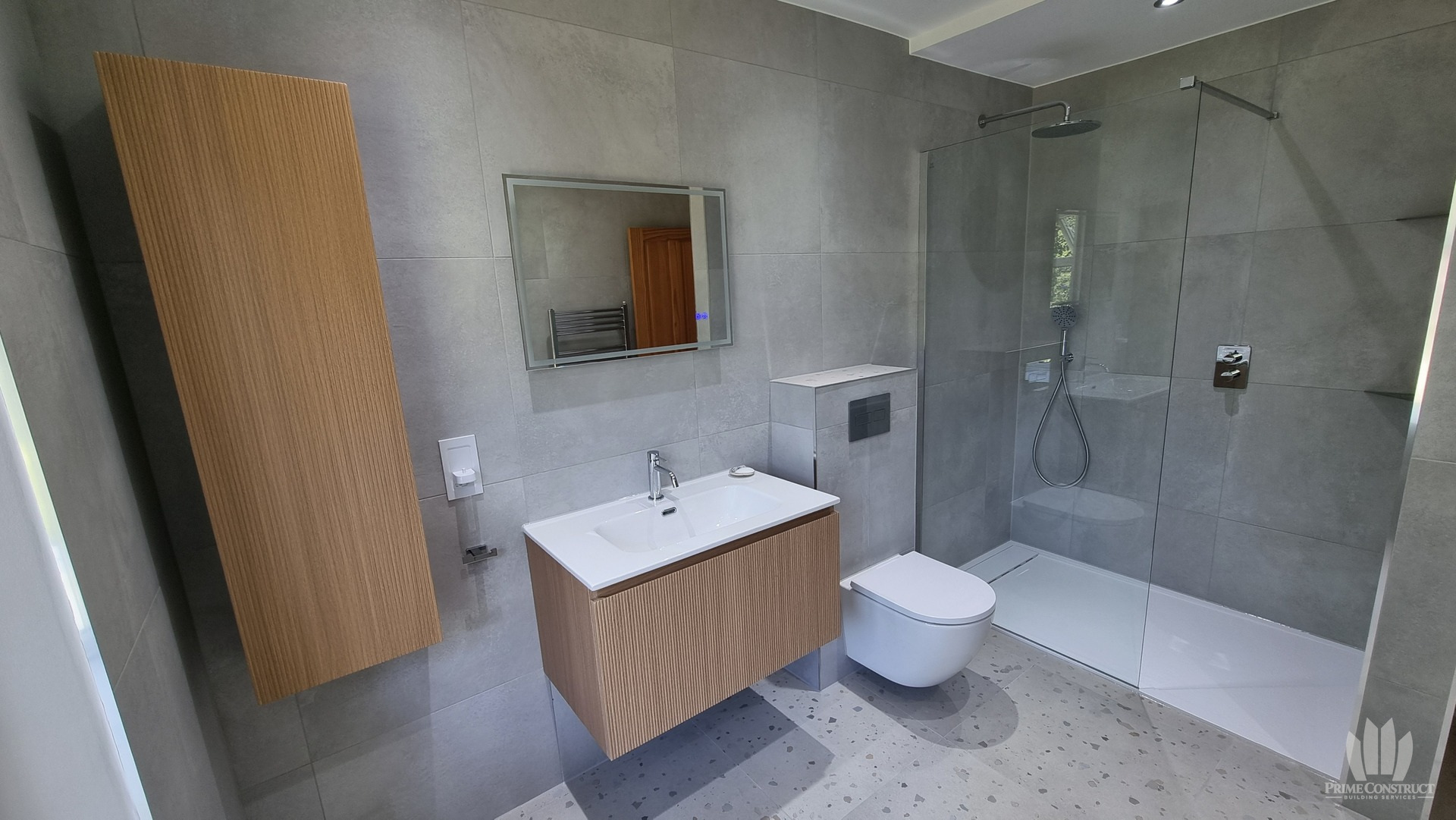 Fluted wood-effect cabinetry, vanity, wall-hung WC and shower