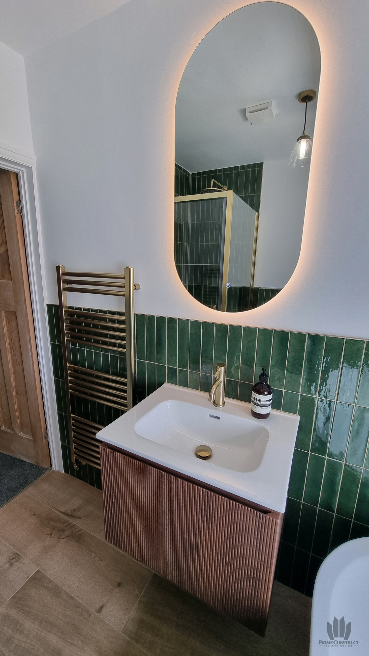 Fluted vanity and illuminated oval mirror