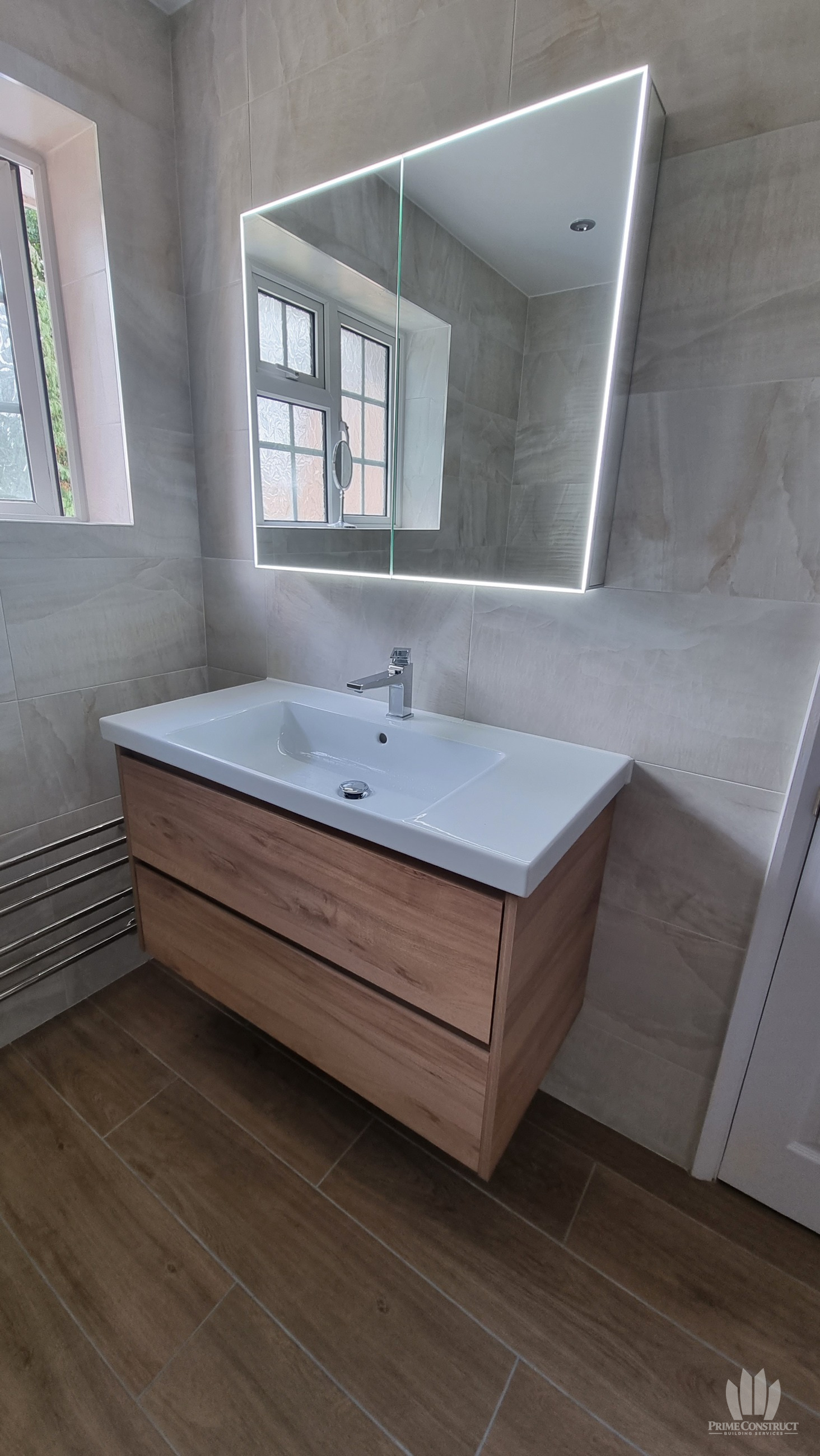 Basin and illuminated mirror