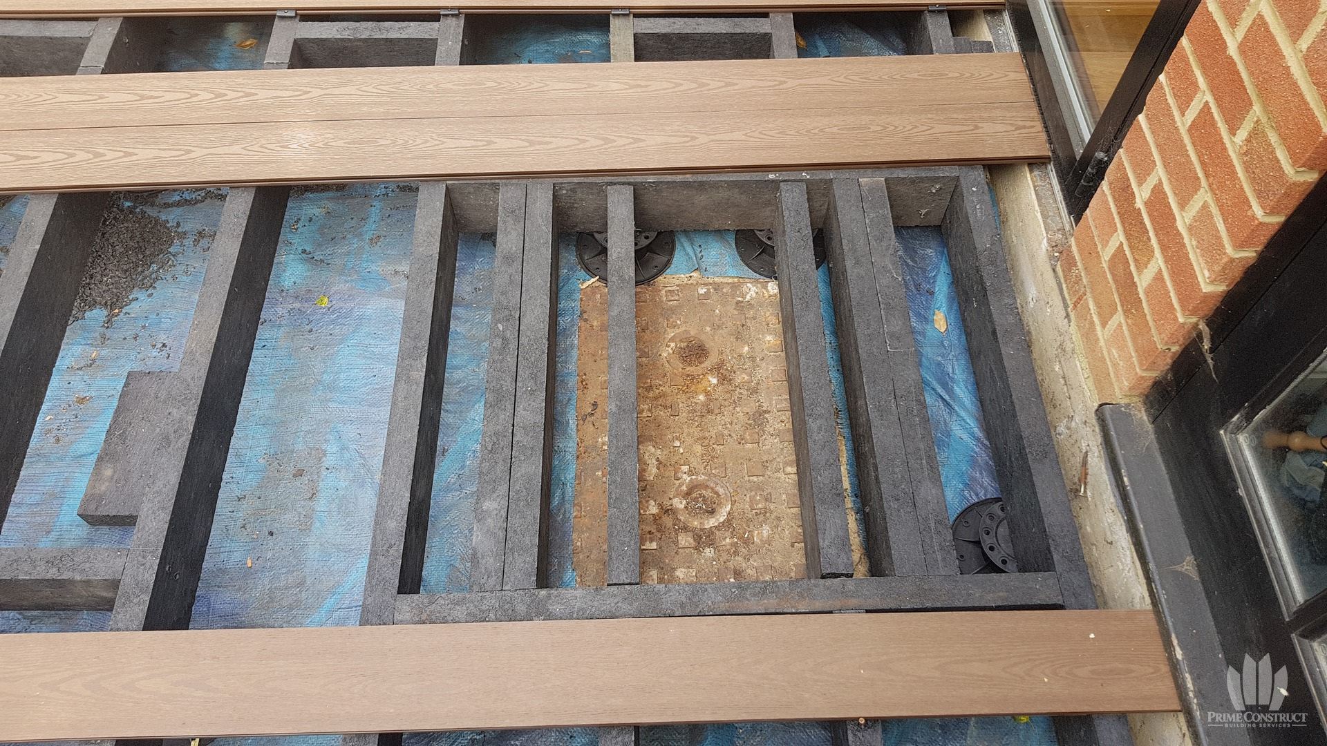 Deck board and substructure detail at doorway.